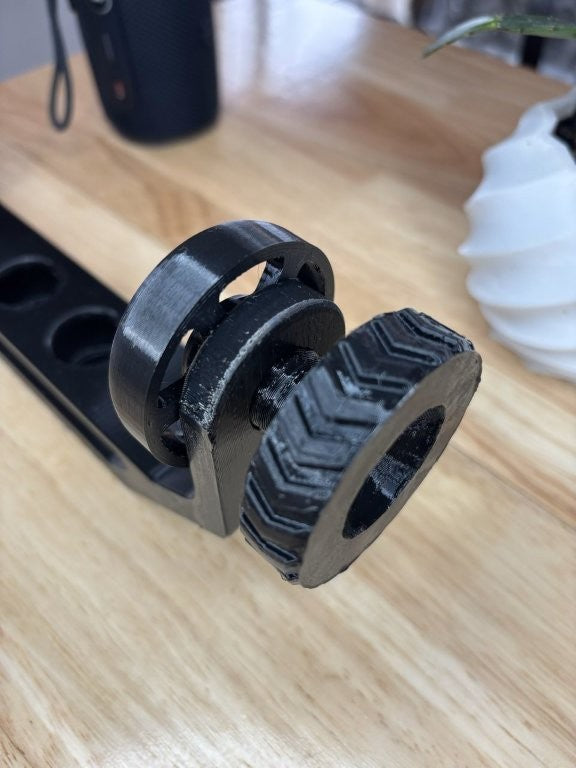 Close-up of adjustable clamp mechanism on a 3D printed speaker mount for JBL Flip 6 style cylindrical speakers tire tread detail