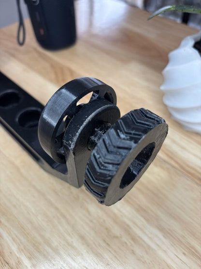 Close-up of adjustable clamp mechanism on a 3D printed speaker mount for JBL Flip 6 style cylindrical speakers tire tread detail