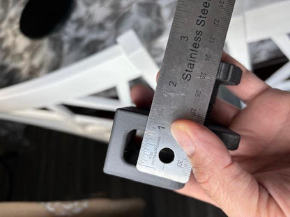 Measurement of shower caddy adapter block showing clamp width with ruler